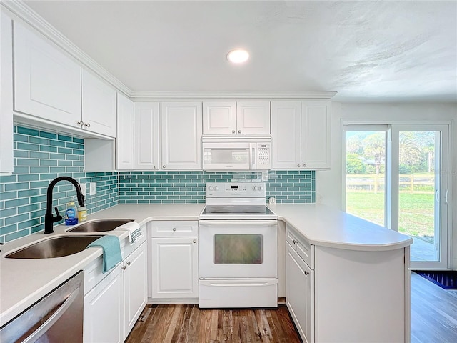 kitchen featuring sink, white cabinetry, tasteful backsplash, wood-type flooring, and white appliances