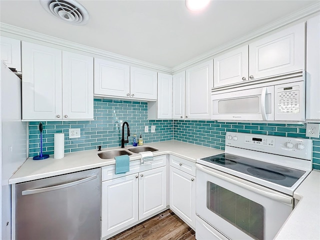 kitchen with dark hardwood / wood-style floors, sink, white cabinets, decorative backsplash, and white appliances