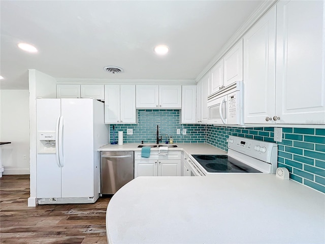 kitchen featuring white cabinetry, sink, and white appliances