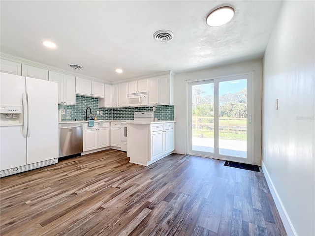 kitchen with white cabinetry, white appliances, tasteful backsplash, and light hardwood / wood-style flooring