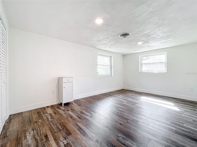 unfurnished room with dark hardwood / wood-style flooring