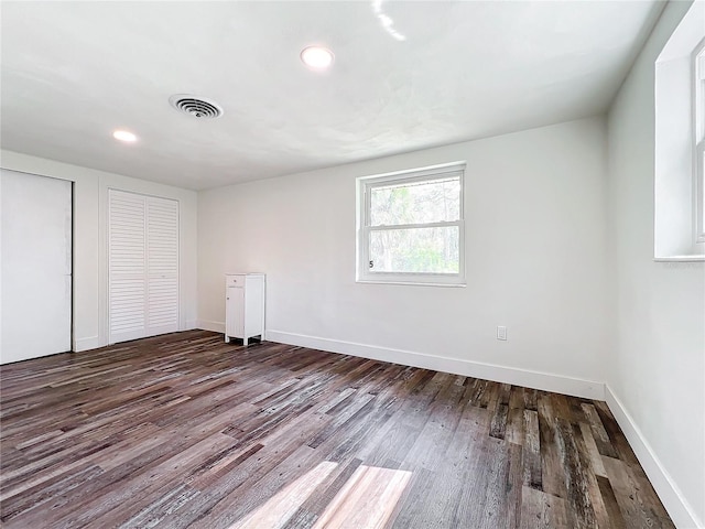 unfurnished bedroom with dark hardwood / wood-style flooring