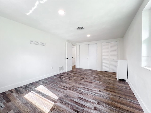 unfurnished bedroom with dark wood-type flooring