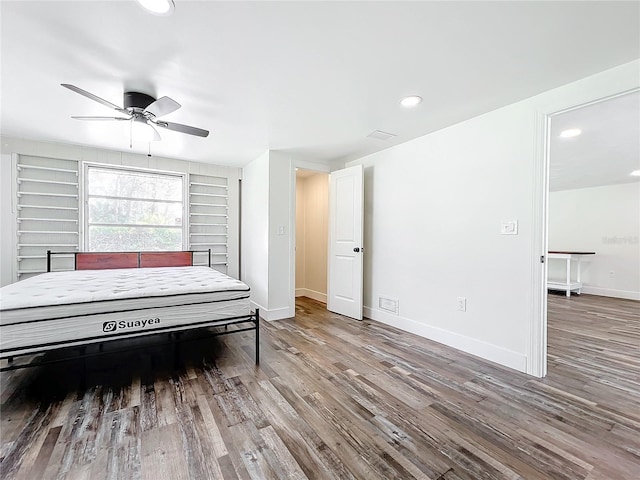 bedroom featuring wood-type flooring and ceiling fan