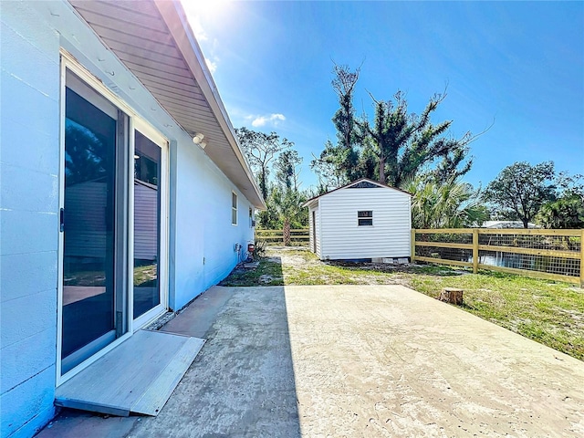 view of patio / terrace featuring a storage unit