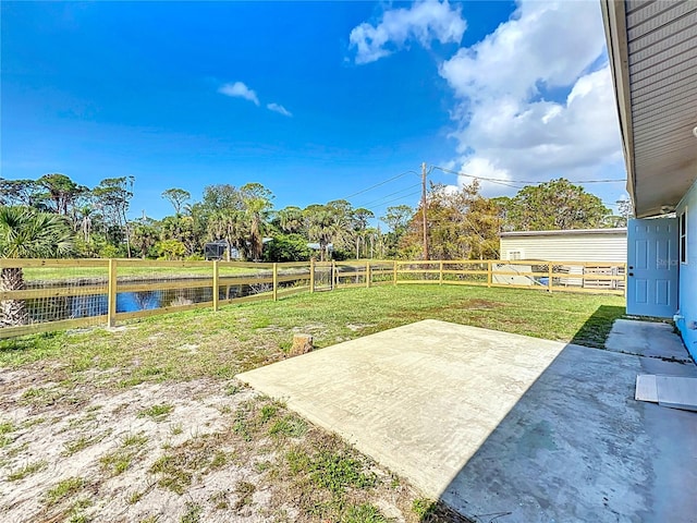 view of yard with a patio area and a water view