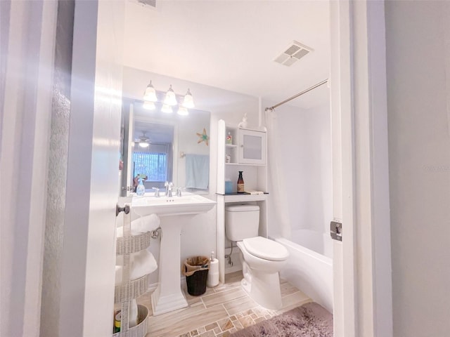 bathroom featuring shower / bath combo with shower curtain and toilet