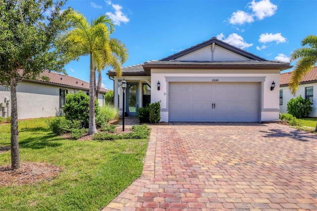 single story home with a garage and a front yard