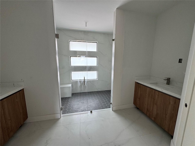 bathroom with vanity and tiled shower