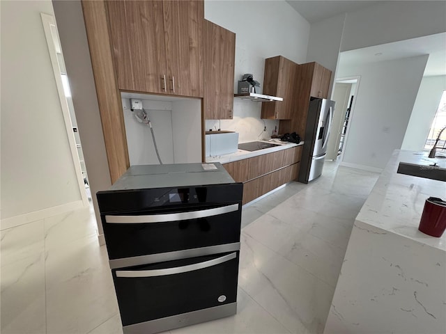 kitchen with black electric cooktop, sink, and stainless steel refrigerator with ice dispenser