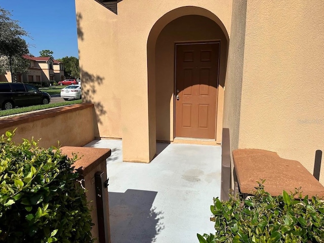 entrance to property featuring stucco siding