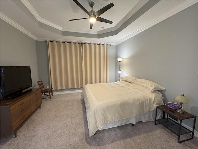 carpeted bedroom featuring ornamental molding, a raised ceiling, and ceiling fan