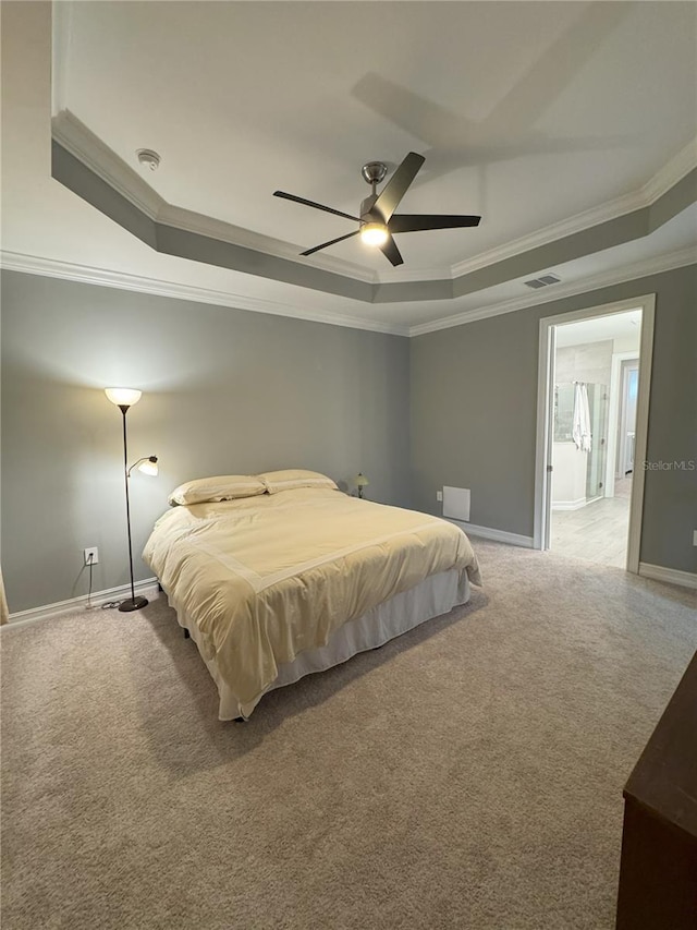 carpeted bedroom with a raised ceiling, ornamental molding, and ceiling fan