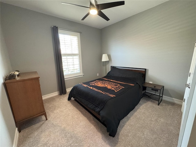 bedroom featuring light carpet and ceiling fan