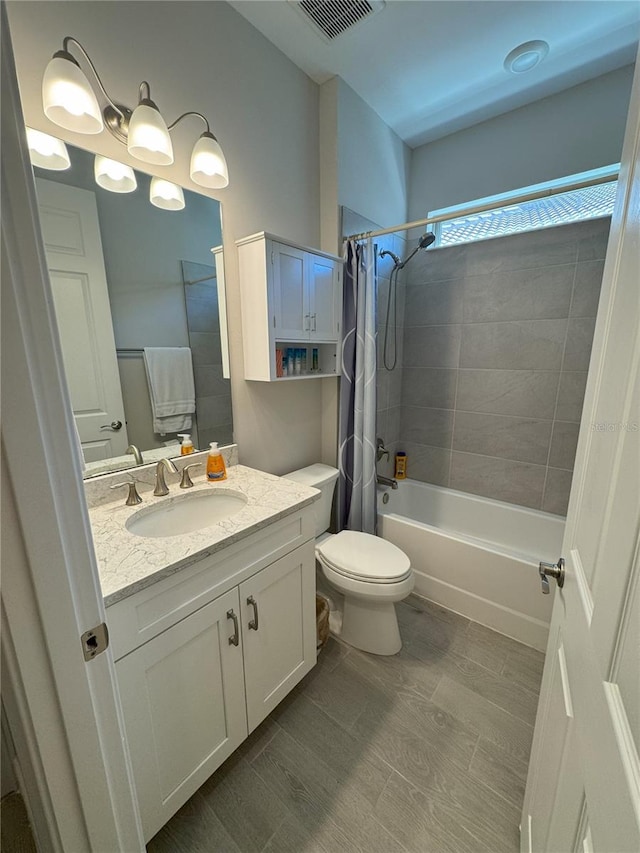 full bathroom featuring vanity, toilet, and shower / bath combo