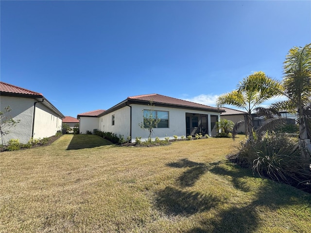 rear view of property featuring a yard