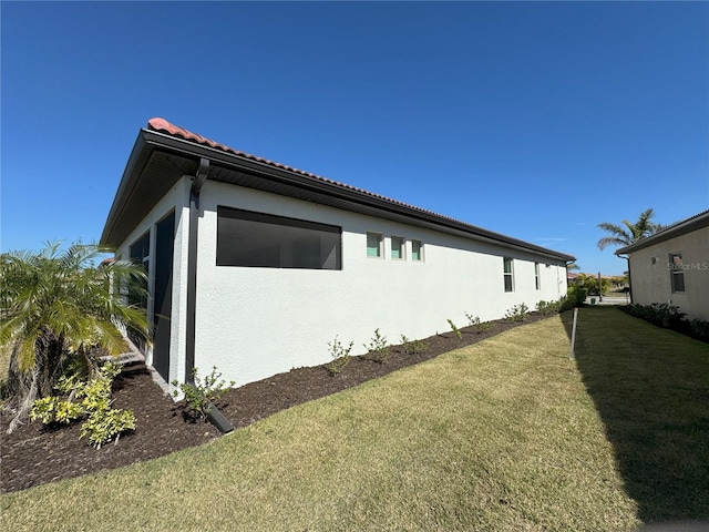 view of home's exterior featuring a lawn