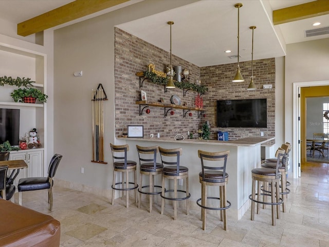 bar with brick wall, beam ceiling, and hanging light fixtures