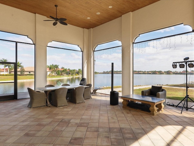 interior space featuring a water view and ceiling fan