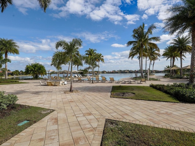 view of home's community featuring a water view and a yard