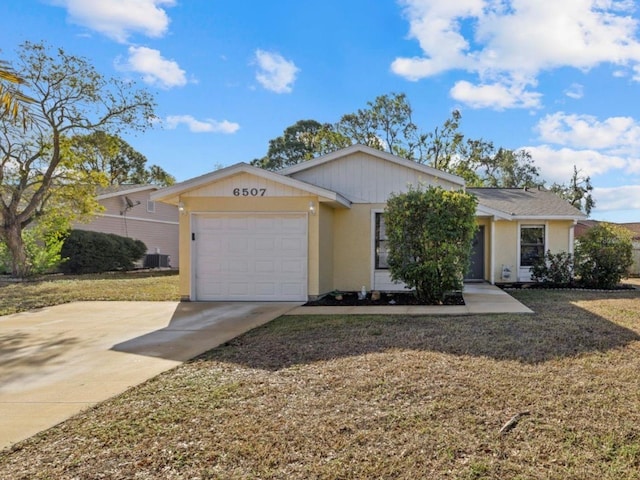 single story home with a garage, central AC, and a front yard