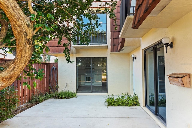 view of exterior entry featuring a patio