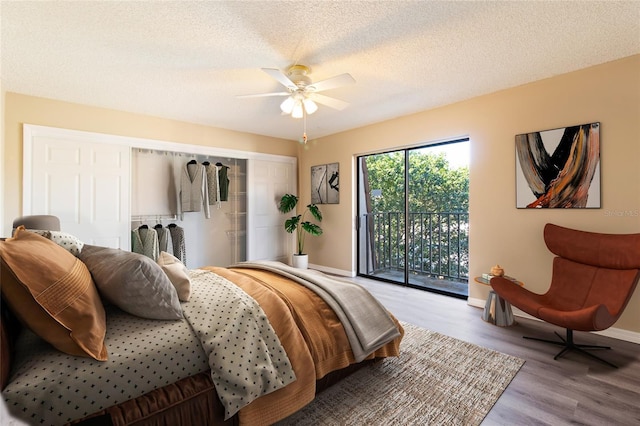 bedroom with wood-type flooring, access to outside, ceiling fan, and a textured ceiling