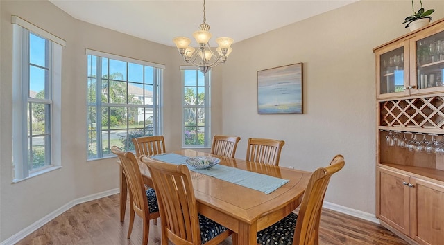 dining area with an inviting chandelier, hardwood / wood-style flooring, and plenty of natural light