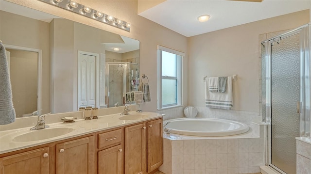 bathroom with vanity and independent shower and bath