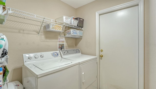 clothes washing area featuring laundry area and washer and dryer