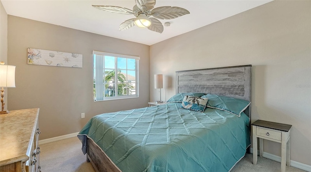 carpeted bedroom featuring ceiling fan and baseboards