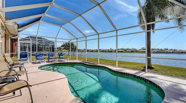 view of swimming pool featuring a water view, a patio area, and glass enclosure