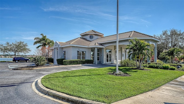 view of front of home featuring a front lawn and stucco siding