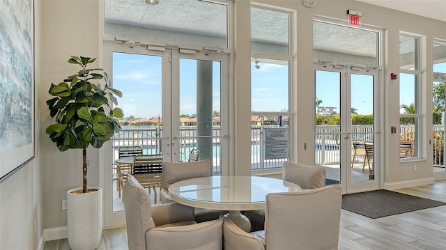 sunroom / solarium featuring french doors