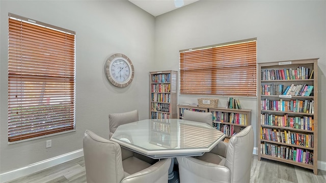 office space featuring baseboards and wood finished floors