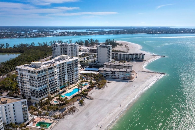 drone / aerial view featuring a water view and a beach view