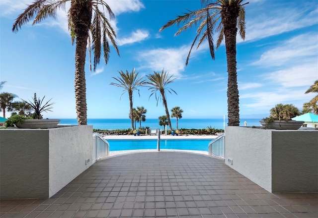 view of pool featuring a water view