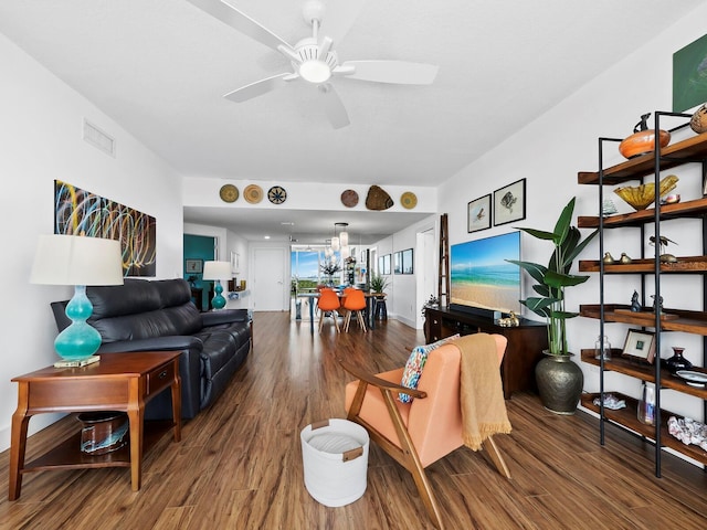 living room featuring wood-type flooring and ceiling fan