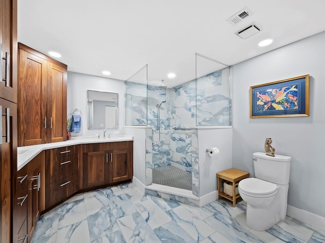 bathroom featuring vanity, toilet, and tiled shower