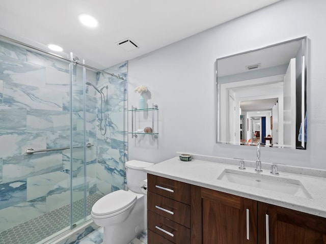 bathroom with vanity, toilet, and a shower with shower door