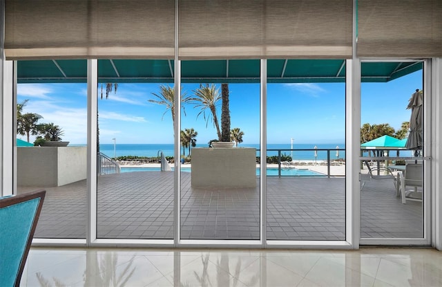 doorway to outside featuring a water view and plenty of natural light