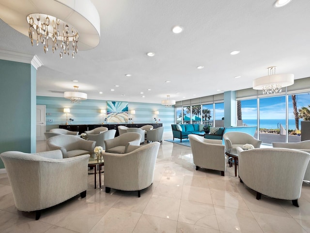 living room featuring a water view, a chandelier, and a textured ceiling