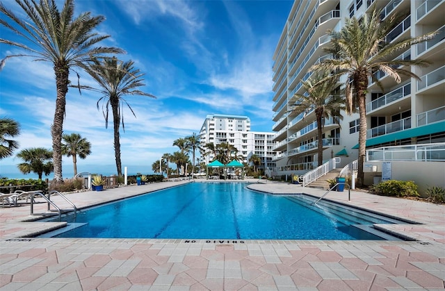 view of swimming pool featuring a patio area