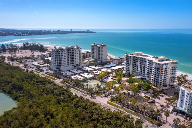 drone / aerial view featuring a water view and a beach view