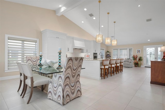 tiled dining space featuring beamed ceiling, sink, and high vaulted ceiling