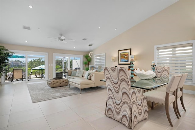 dining room featuring high vaulted ceiling, light tile patterned floors, and ceiling fan