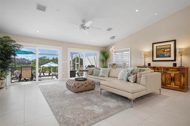 tiled living room with lofted ceiling and ceiling fan