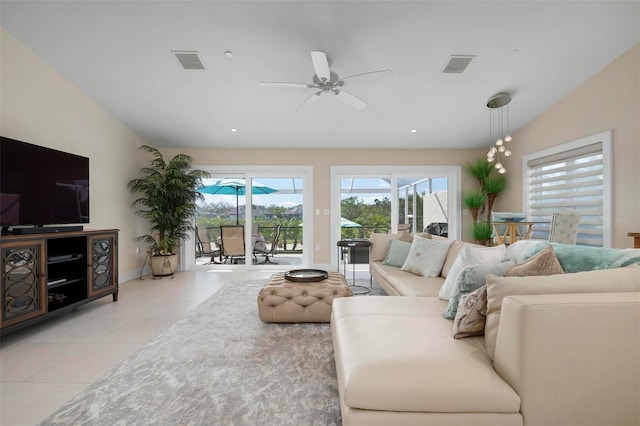 living room with light tile patterned floors, vaulted ceiling, and ceiling fan