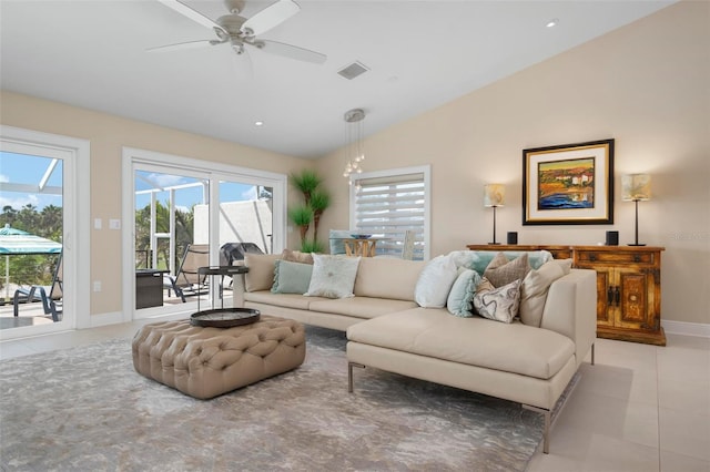 living room featuring lofted ceiling, light tile patterned floors, and ceiling fan