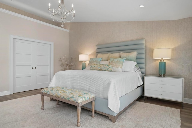 bedroom featuring a notable chandelier and hardwood / wood-style flooring